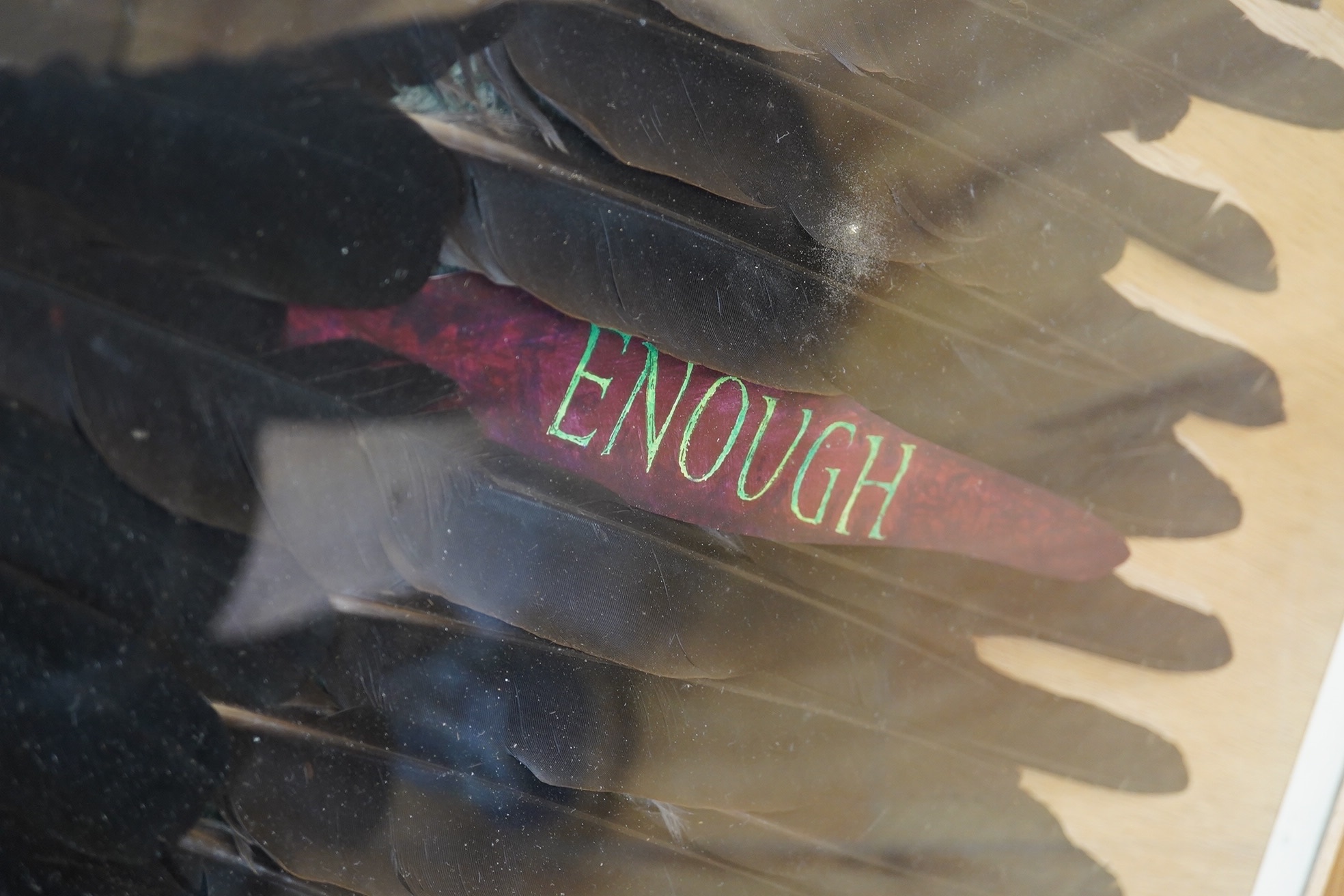 A framed American feather appliqué with message “To Live At All Is A Miracle Enough”, 84cm high, 53wide. Condition - good